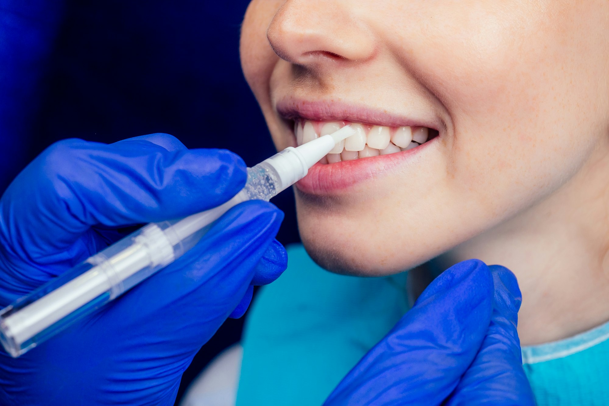 dentist works on tooth crown in dental laboratory