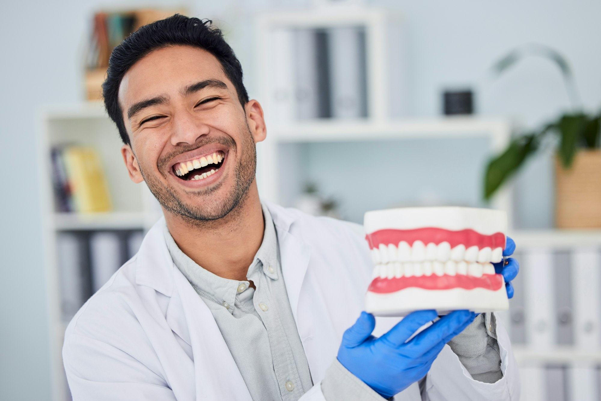 Happy asian man, dentist and teeth for dental care, veneers or healthcare at hospital. Portrait of